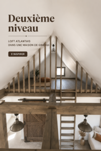 Un loft moderne aménagé dans une barn house avec des matériaux bruts et un mobilier chaleureux.